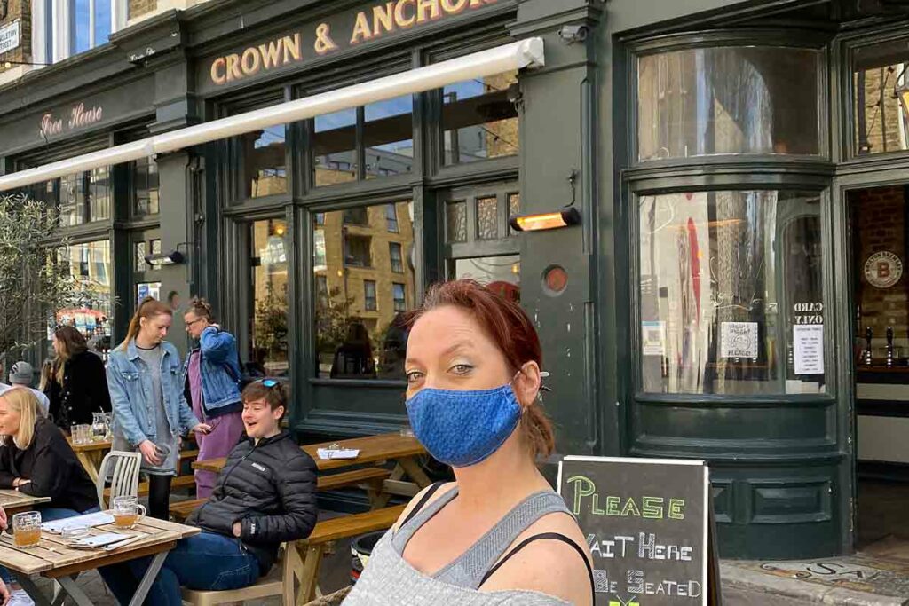woman Coid mask outside pub
